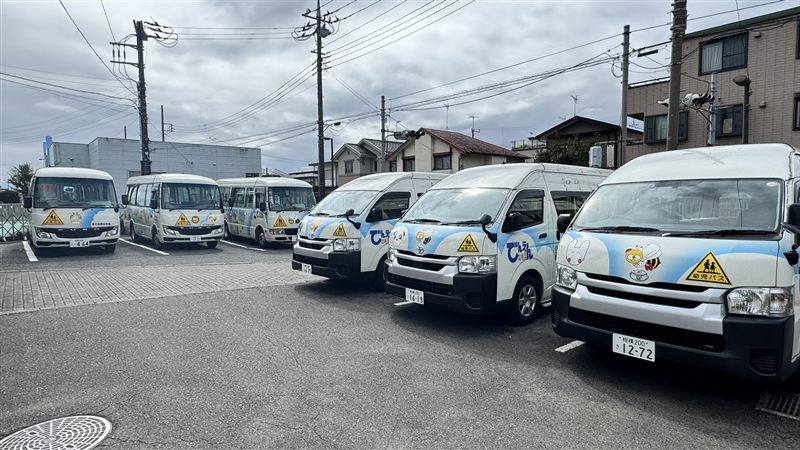Our school buses lined up in the kindergarten parking lot