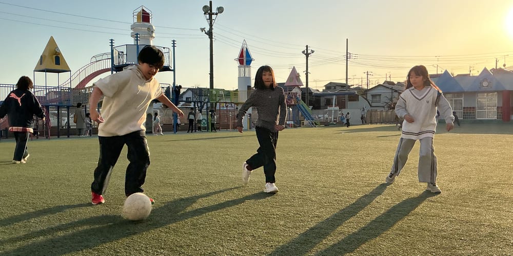 After-school club children playing ball in the playground