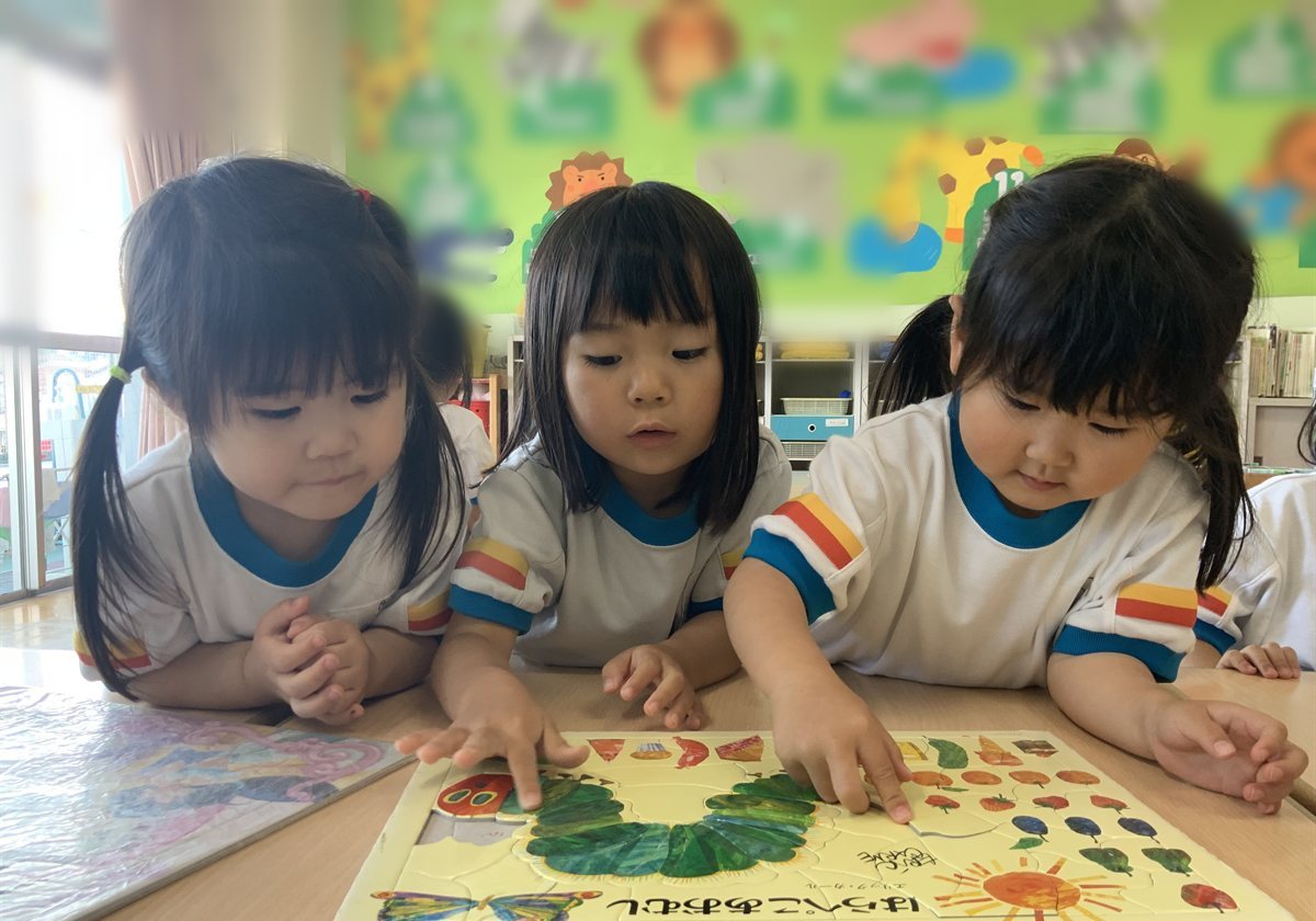 Children in extended care working carefully on a puzzle