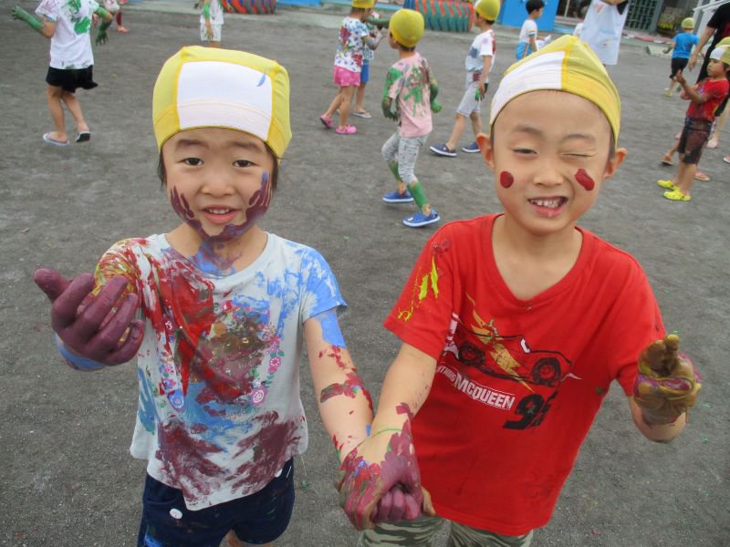 Children thoroughly enjoying messy play in the mud