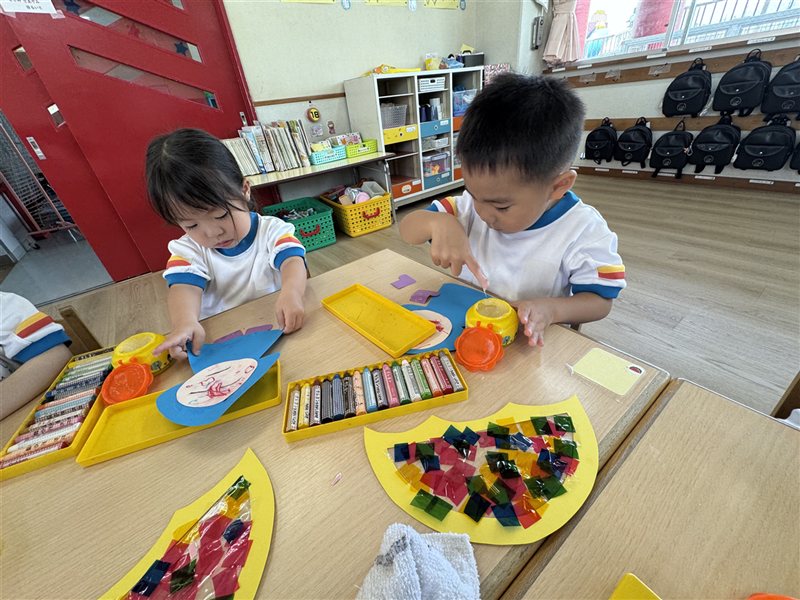Children making crafts with crayons and glue