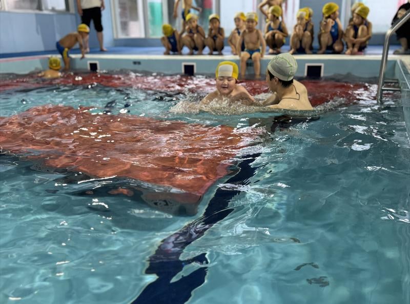 A child swimming in the indoor heated pool